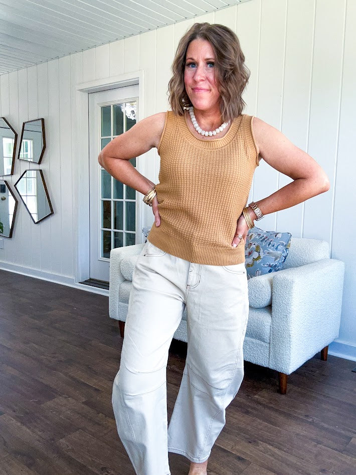 Soft waffle textured knit tank top with round neck and wide hem.