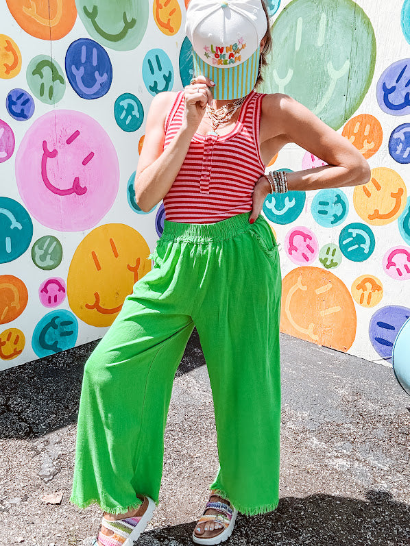 Linen and cotton blend flowy wide leg pants with elastic waist, pockets and frayed hem and pockets.