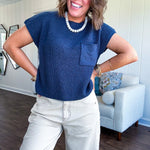 Lightweight dolman style cropped knit sweater with short sleeves, front pocket and available in three colors.