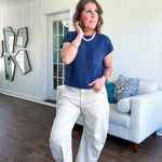 Lightweight dolman style cropped knit sweater with short sleeves, front pocket and available in three colors.