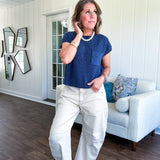 Lightweight dolman style cropped knit sweater with short sleeves, front pocket and available in three colors.