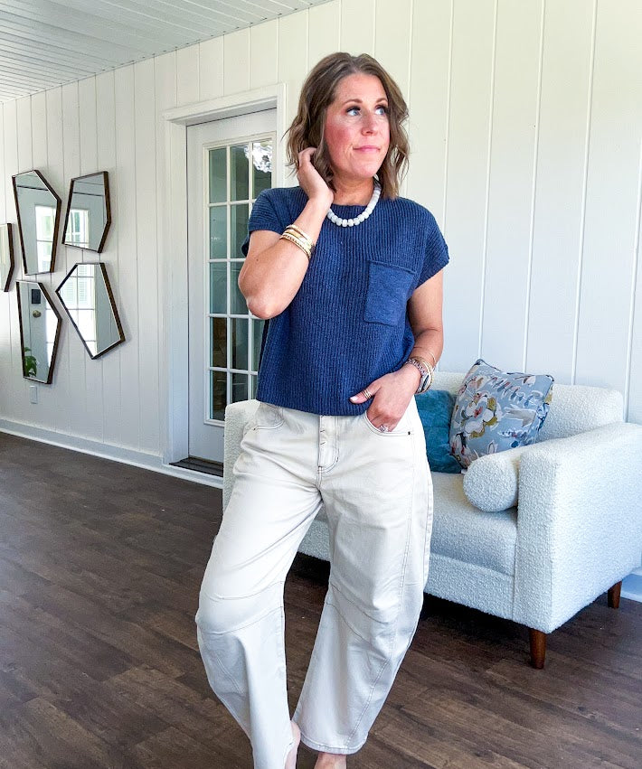 Lightweight dolman style cropped knit sweater with short sleeves, front pocket and available in three colors.