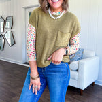Lightweight dolman style cropped knit sweater with short sleeves, front pocket and available in three colors.