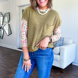 Lightweight dolman style cropped knit sweater with short sleeves, front pocket and available in three colors.