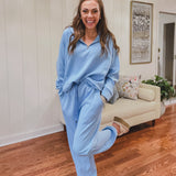 Light blue travel set with 1/4 zip top and elastic waist and cuffs on the pants.