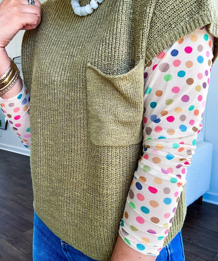 Cream multi colored polka dot long sleeved mesh with round neck.