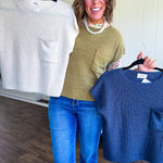 Lightweight dolman style cropped knit sweater with short sleeves, front pocket and available in three colors.