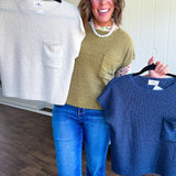 Lightweight dolman style cropped knit sweater with short sleeves, front pocket and available in three colors.