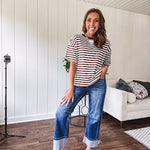 Terry-like short sleeved top with dark brown and cream stripes, split hem and maroon trim at the round neck.