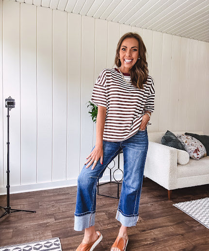 Terry-like short sleeved top with dark brown and cream stripes, split hem and maroon trim at the round neck.