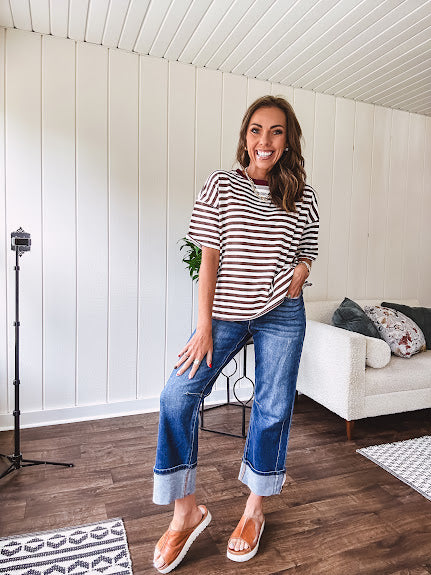 Terry-like short sleeved top with dark brown and cream stripes, split hem and maroon trim at the round neck.