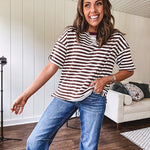 Terry-like short sleeved top with dark brown and cream stripes, split hem and maroon trim at the round neck.