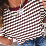 Terry-like short sleeved top with dark brown and cream stripes, split hem and maroon trim at the round neck.