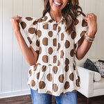 Lightweight and flowy cream top with khaki polka dots throughout with flutter sleeve 3/4 button down front and ruffle hem with pintucking down the placket.
