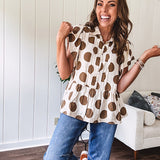 Lightweight and flowy cream top with khaki polka dots throughout with flutter sleeve 3/4 button down front and ruffle hem with pintucking down the placket.