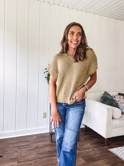 Olive woven drop shoulder sweater blouse with short sleeves and V shaped design n the front.