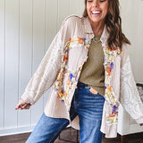 Beige cotton shacket with floral peace patch across the front, lace sleeves and metal buttons down the front. Oversized.