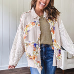 Beige cotton shacket with floral peace patch across the front, lace sleeves and metal buttons down the front. Oversized.