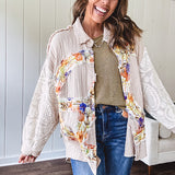 Beige cotton shacket with floral peace patch across the front, lace sleeves and metal buttons down the front. Oversized.