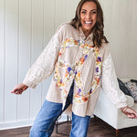 Beige cotton shacket with floral peace patch across the front, lace sleeves and metal buttons down the front. Oversized.