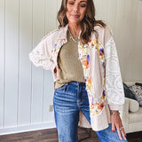 Beige cotton shacket with floral peace patch across the front, lace sleeves and metal buttons down the front. Oversized.