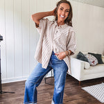 Oversized cotton blend khaki dolman style button front top with raw seams, cuffed short sleeves and dainty floral patterns in spice with mixed textures.