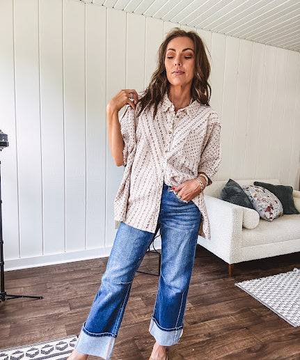 Oversized cotton blend khaki dolman style button front top with raw seams, cuffed short sleeves and dainty floral patterns in spice with mixed textures.