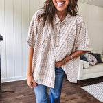 Oversized cotton blend khaki dolman style button front top with raw seams, cuffed short sleeves and dainty floral patterns in spice with mixed textures.