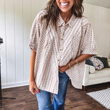 Oversized cotton blend khaki dolman style button front top with raw seams, cuffed short sleeves and dainty floral patterns in spice with mixed textures.