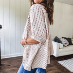 Oversized cotton blend khaki dolman style button front top with raw seams, cuffed short sleeves and dainty floral patterns in spice with mixed textures.