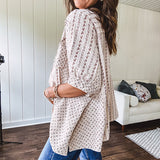 Oversized cotton blend khaki dolman style button front top with raw seams, cuffed short sleeves and dainty floral patterns in spice with mixed textures.