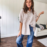 Oversized cotton blend khaki dolman style button front top with raw seams, cuffed short sleeves and dainty floral patterns in spice with mixed textures.