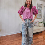 Teal and pink plaid denim-like pants with lace drawstring and patchwork and distressing throughout, raw hem and wide leg.