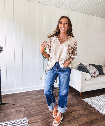 Oversized, lightweight stretchy beige ribbed top with a mix of wheat and dark tan crochet inserts and trim throughout with ivory crochet florals, hoodie and lace drawstring with lace at the wide hem and short sleeved cuffs.