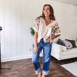 Oversized, lightweight stretchy beige ribbed top with a mix of wheat and dark tan crochet inserts and trim throughout with ivory crochet florals, hoodie and lace drawstring with lace at the wide hem and short sleeved cuffs.