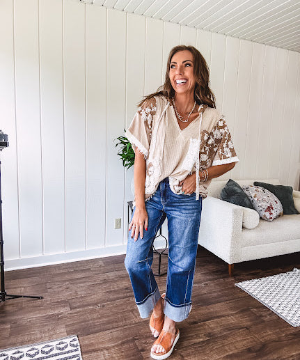 Oversized, lightweight stretchy beige ribbed top with a mix of wheat and dark tan crochet inserts and trim throughout with ivory crochet florals, hoodie and lace drawstring with lace at the wide hem and short sleeved cuffs.