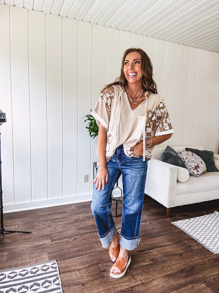Oversized, lightweight stretchy beige ribbed top with a mix of wheat and dark tan crochet inserts and trim throughout with ivory crochet florals, hoodie and lace drawstring with lace at the wide hem and short sleeved cuffs.