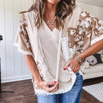 Oversized, lightweight stretchy beige ribbed top with a mix of wheat and dark tan crochet inserts and trim throughout with ivory crochet florals, hoodie and lace drawstring with lace at the wide hem and short sleeved cuffs.