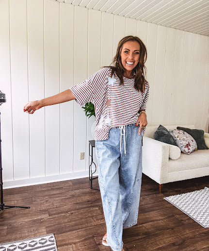 Light wash slouchy cropped barrel denim with elastic waist, seam details down the sides of the legs and side pockets.