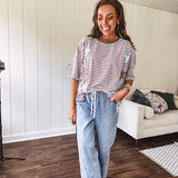Oversized terry knit short sleeved top with cream, espresso and light blue striping and star patches throughout with exposed seams down the sides of the front and a split front hem.