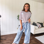 Light wash slouchy cropped barrel denim with elastic waist, seam details down the sides of the legs and side pockets.