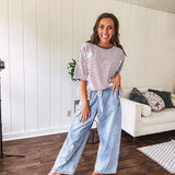 Light wash slouchy cropped barrel denim with elastic waist, seam details down the sides of the legs and side pockets.