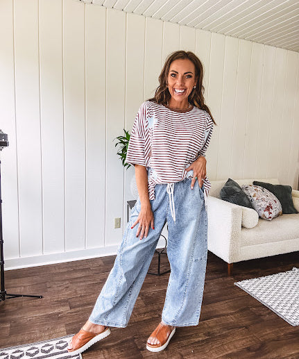 Light wash slouchy cropped barrel denim with elastic waist, seam details down the sides of the legs and side pockets.