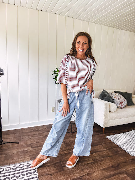 Light wash slouchy cropped barrel denim with elastic waist, seam details down the sides of the legs and side pockets.