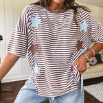 Oversized terry knit short sleeved top with cream, espresso and light blue striping and star patches throughout with exposed seams down the sides of the front and a split front hem.