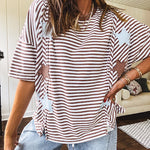Oversized terry knit short sleeved top with cream, espresso and light blue striping and star patches throughout with exposed seams down the sides of the front and a split front hem.