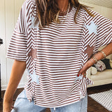 Oversized terry knit short sleeved top with cream, espresso and light blue striping and star patches throughout with exposed seams down the sides of the front and a split front hem.