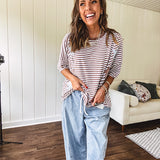 Oversized terry knit short sleeved top with cream, espresso and light blue striping and star patches throughout with exposed seams down the sides of the front and a split front hem.