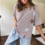 Oversized terry knit short sleeved top with cream, espresso and light blue striping and star patches throughout with exposed seams down the sides of the front and a split front hem.