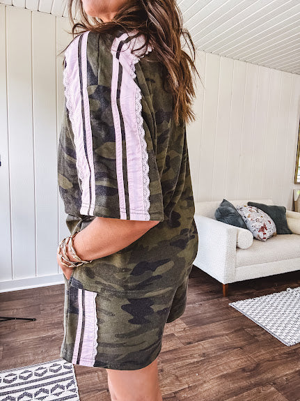 Thin, lightweight dark camo short sleeved top with light pink striping and lace detail at the sleeves.